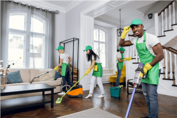 Person starting a home cleaning business by cleaning a client's living room