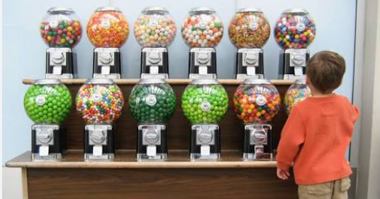 How to Start a Candy Machine Business Without Losing Your Shirt on Bad Locations Small business owner restocking a candy vending machine business machine in an office break room