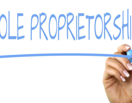 How to Start a Sole Proprietorship Without Losing Your Mind Freelancer managing sole proprietorship paperwork at home