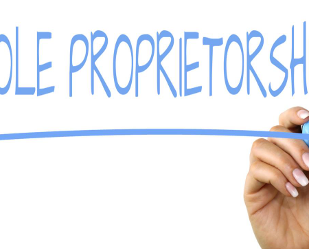 How to Start a Sole Proprietorship Without Losing Your Mind Freelancer managing sole proprietorship paperwork at home