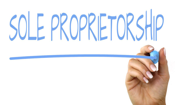 How to Start a Sole Proprietorship Without Losing Your Mind Freelancer managing sole proprietorship paperwork at home